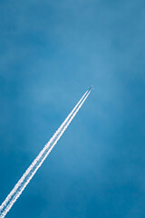 Contrail In Blue Sky. Plane In Sunny Sky Background. Airplane Aircraft In Sky With Plane Trails