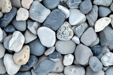 Heap of small pebbles in a closeup view, natural background texture with stones and rocks pile up