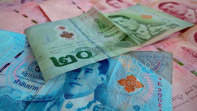 Close-up of a pile of twenty baht, fifty baht, one hundred, five hundred and one thousand Thai baht (THB) notes of Thailand. high-resolution background images.