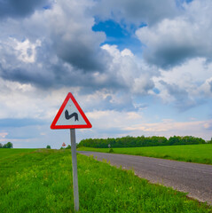 long asphalt road under a dense cloudy sky