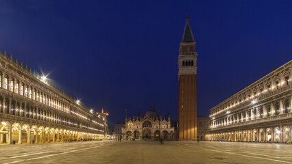 An empty illuminated San Marco square with the bell tower and the cathedral at blue hour on a winter evening, Venice, Veneto, Italy - obrazy, fototapety, plakaty