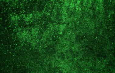 Fototapeta premium A textured green grunge background with dark patches and rough surface