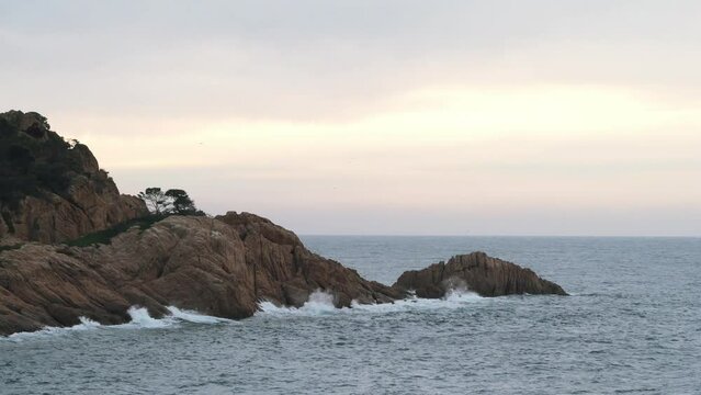 Waves crushing on the coastline rocks