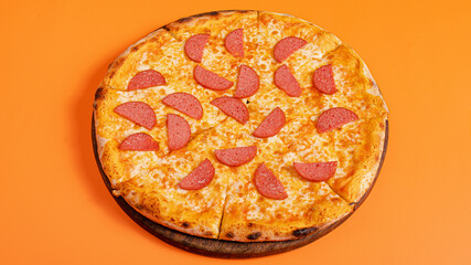 Sausage pizza isolated on orange background