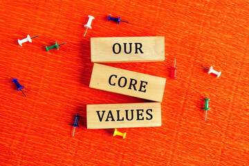 Concept words OUR CORE VALUES symbol on wooden blocks. Bright background. The concept of business...
