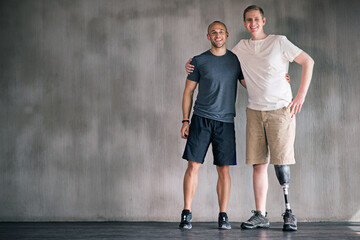 Naklejka premium happy, physiotherapist and man with disability in portrait with prosthetic leg in mockup space. Studio, background and orthopedic healthcare or rehabilitation for disabled male person with smile