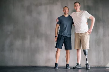 Poster happy, physiotherapist and man with disability in portrait with prosthetic leg in mockup space. Studio, background and orthopedic healthcare or rehabilitation for disabled male person with smile © peopleimages.com