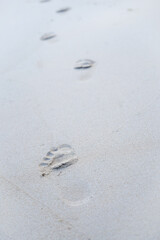 Wave footprints on the sand beach, nature summer on the sandy beach near the sea shore. Tourist travel concept. Vertical.
