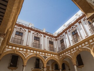The main courtyard of the old historical women's hospital Nuestra Senora del Carmen hospital in Cádiz, Andalusia, Spain © MatyasSipos