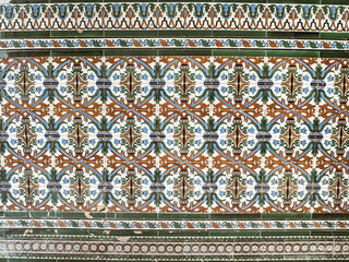 A pattern made of traditional colorful floral Spanish tiles on a wall