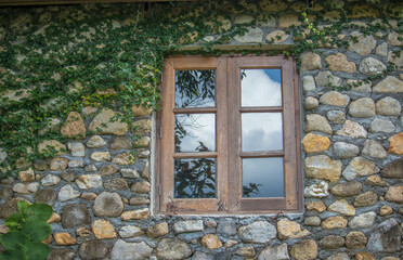 Windows of the old castle. There’s green grass under the windows.