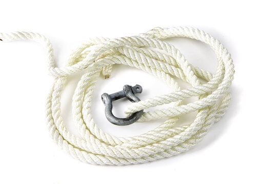 A loop of white colored poly rope line with an old galvanized chain shackle and clevis pin isolated on white