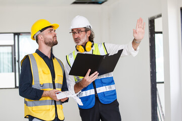 Foreman and client discuss on a building plan and construction.