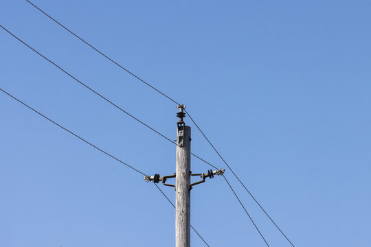A high voltage transmission pole with three wires on standoff insulators