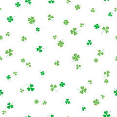 Seamless pattern of flying green clover leaves, three and four leaf. Vector illustration for textiles, wrapping paper, wallpaper. 