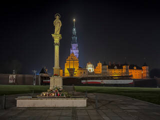Jasna Gora Monastery and the column with the Blessed Virgin Mary in Czestochowa at night. The inscription on the banner in Polish "Jesus meets his mother"