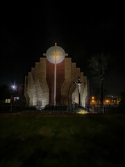 Parish of the Most Holy Body and Blood of Christ in Czestochowa, Poland. View of the church from the outside at night. "The Unity of the Cross and the Eucharist"