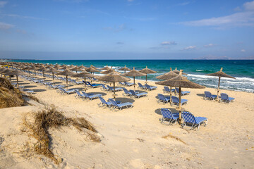 Sunbeds with umbrella on sandy beach of Marmari. The Greek island of Kos
