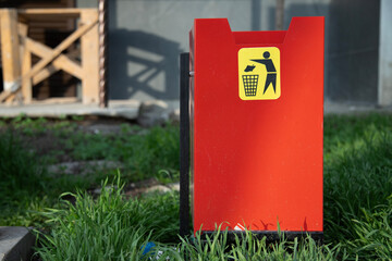 Red trash bin on street