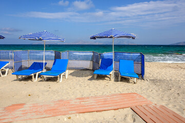 Sunbeds with umbrella on sandy beach of Marmari. The Greek island of Kos