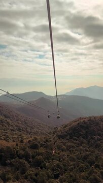 Hong Kong &ndash; March 17th 2024 : Breathtaking view of cable car Ngong Ping 360, at Lantau Island, Hong Kong. Motion video taken on sunset sky. Famous with the cable car to see the hills and country side 