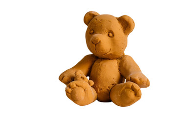 Isolated on a transparent background, a cute toy teddy bear made by hand using plastercine play dough