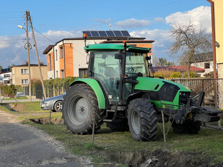 A tractor parked in front of the house, just like a car