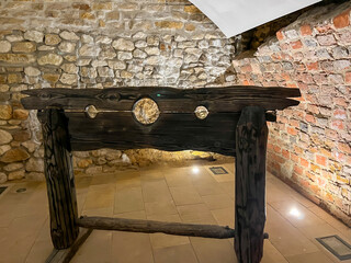 Old stocks - an instrument of torture located in the ruins of the Rabsztyn castle near Olkusz in Poland - 778351176