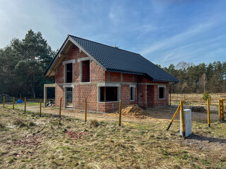 A single-family house built of ceramic blocks with a tile roof in a shell state. - 778351731
