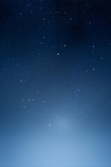 Fototapeta premium A serene night sky with twinkling white stars against a dark blue backdrop evokes a sense of peace and tranquility. 