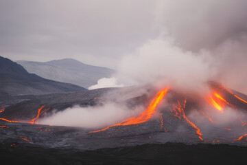 Fototapeta premium Red flames and smoke billow from a mountain forest fire, threatening the natural landscape