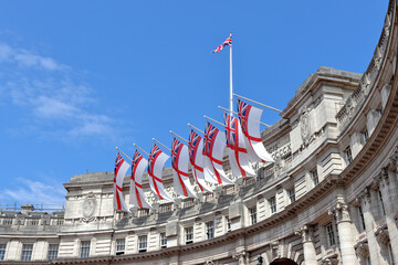 White Ensign flags flying on Admiralty Arch which connects The Mall and Trafalgar Square in London - obrazy, fototapety, plakaty