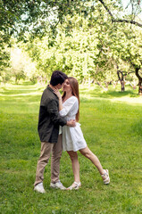Fototapeta premium young couple in love on a picnic in summer park