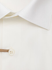 Button placket on an ivory dress shirt, close-up