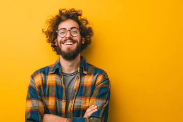A man with a beard and glasses is smiling and posing for a picture - Powered by Adobe