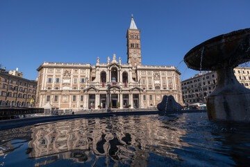 Basilica Papale di Santa Maria Maggiore catholic cathedral and fountain water reflection, Rome,...
