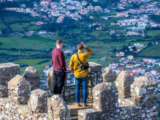 People are looking from one of the towers of Moors Castle in Sintra, Portugal