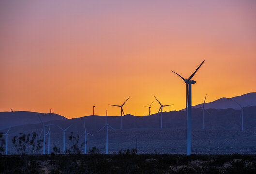 Sunset over the windmill farm in Palm Springs, California at the foot of the San Jacinto Mountains, adjacent to Highway 111, which helps provide energy for the Coachella Valley in Riverside County.