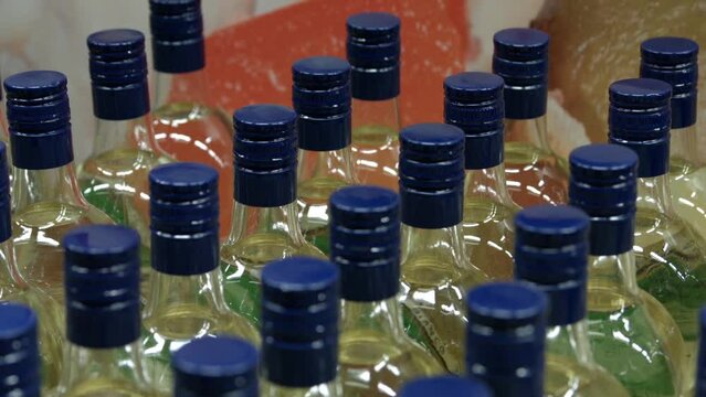 Olive Oil Bottles with Blue Caps in Abstract Setting