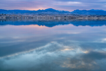dusk over calm lake in Colorado foothills of Rocky Mountains, Boedecker Reservoir in early spring