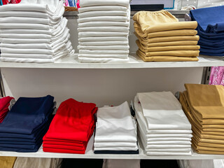 A row of T-shirts are stacked on top of each other