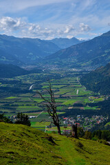 view into a scenic valley surrounded by high mountains