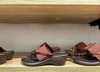 Trendy ladies sandals slippers on shelf in shop