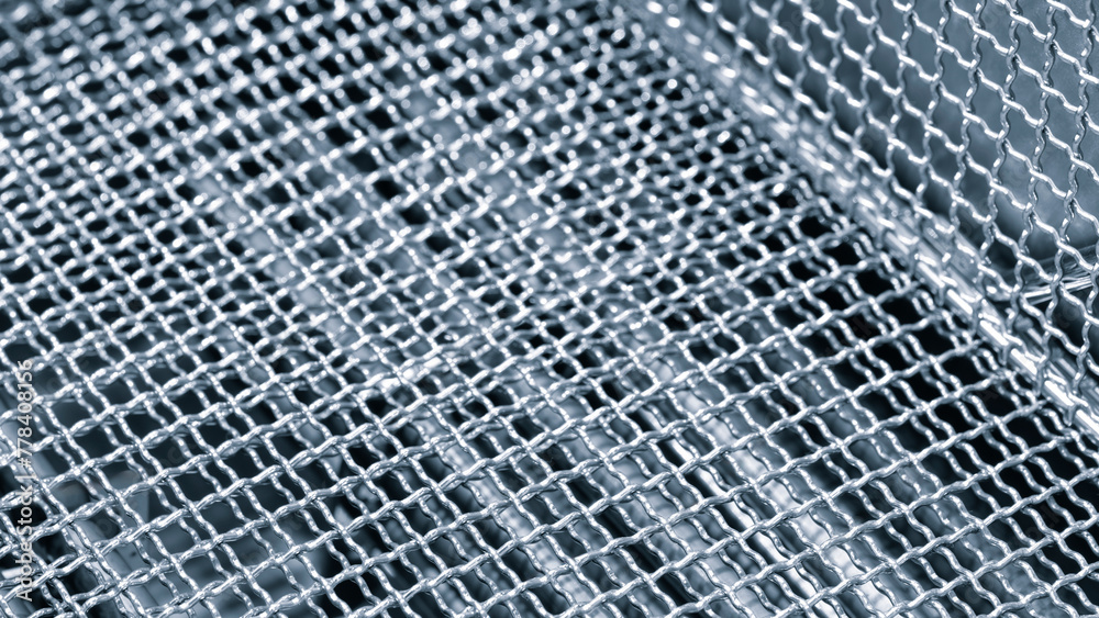 Poster a close up of a metal mesh with a silver color. the mesh is made of metal and has a pattern