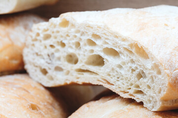 A slice of bread with a hole in it. The bread is white and has a hole in the middle