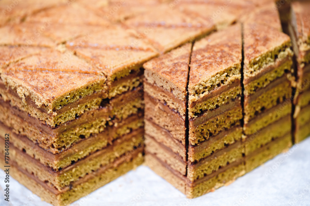 Poster A stack of brownies with a crosshatch pattern. The brownies are cut into squares and arranged in a pyramid shape
