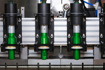 A machine with four green cylinders on it