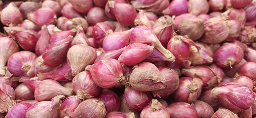 Pile of fresh red onions background