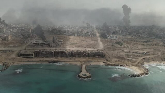 Gaza city destroyed in the war withcoastline, aerial wide shot,
Drone view over North Gaza buildings bombarded,Gaza-March,20,2024
