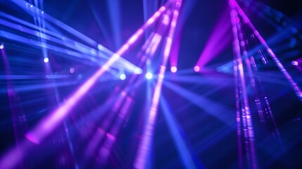 Laser beams in blue and violet colors illuminate a dark backdrop.